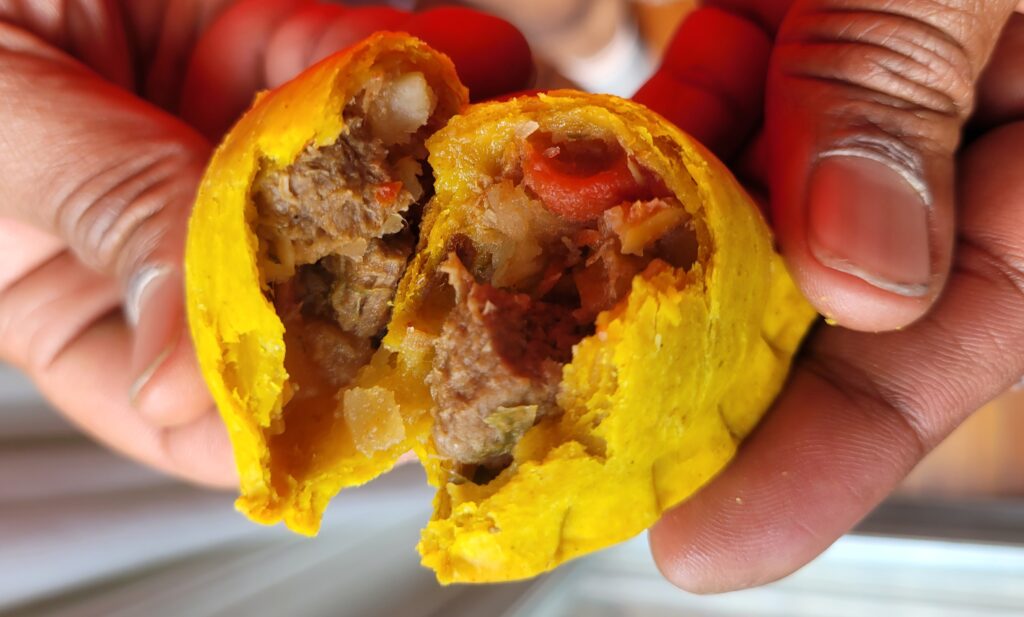 Close-up of a flaky golden patty with seasoned filling
